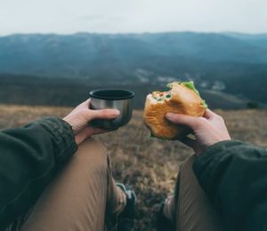 Traveler woman have lunch on nature. Point of view shot